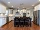 Bright kitchen featuring white cabinets, stainless steel appliances, granite countertops, and a center island with seating at 1108 Kalworth Rd, Wake Forest, NC 27587