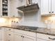 Close up of updated kitchen featuring granite countertops, white cabinets, and stainless steel appliances at 1108 Kalworth Rd, Wake Forest, NC 27587