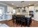 Spacious kitchen with white cabinetry, granite countertops, stainless steel appliances, and center island seating at 1108 Kalworth Rd, Wake Forest, NC 27587