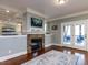 Cozy living room with brick fireplace, access to the screened porch and hardwood floors at 1108 Kalworth Rd, Wake Forest, NC 27587