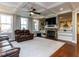 Spacious living room with a stone fireplace and coffered ceilings with large windows at 1108 Kalworth Rd, Wake Forest, NC 27587