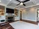 Living room view features a stone fireplace, built-in shelves, and coffered ceilings at 1108 Kalworth Rd, Wake Forest, NC 27587