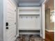 Welcoming mudroom with a built-in bench, coat hooks, and stylish tile flooring at 1108 Kalworth Rd, Wake Forest, NC 27587