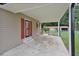 Outdoor covered patio with a concrete floor and red door at 113 Gulf Drive Dr, Dunn, NC 28334