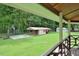 Backyard view of the exterior with shed, basketball hoop, and lush greenery provides a perfect space for outdoor activities at 113 Gulf Drive Dr, Dunn, NC 28334