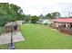 Lush backyard featuring a sports court, shed, and ample green space surrounded by mature trees and a fenced garden at 113 Gulf Drive Dr, Dunn, NC 28334