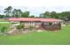 Aerial view of a house with a spacious yard, fenced area, a deck, and a covered parking area at 113 Gulf Drive Dr, Dunn, NC 28334