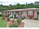 Charming single-story home featuring a manicured lawn and red window shutters at 113 Gulf Drive Dr, Dunn, NC 28334