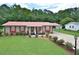 Well-maintained home with a manicured lawn, red roof and shutters, and mature landscaping at 113 Gulf Drive Dr, Dunn, NC 28334