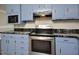 Functional kitchen with stainless steel appliances, ample counter space, and blue cabinets at 113 Gulf Drive Dr, Dunn, NC 28334