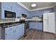 Charming kitchen with blue cabinets, black countertops, stainless steel appliances at 113 Gulf Drive Dr, Dunn, NC 28334