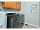 Modern laundry room featuring front load washer/dryer and storage at 113 Gulf Drive Dr, Dunn, NC 28334