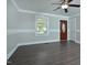 Living room with hardwood floors, crown molding, fresh paint, front door, and ceiling fan at 113 Gulf Drive Dr, Dunn, NC 28334