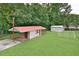 View of backyard shed, storage, and open yard space, perfect for outdoor activities or gardening at 113 Gulf Drive Dr, Dunn, NC 28334