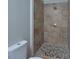 Updated tiled shower with river rock floor and new fixtures at 113 Gulf Drive Dr, Dunn, NC 28334