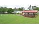 The back of the house looks out over a large, grassy yard, and a fenced garden area at 113 Gulf Drive Dr, Dunn, NC 28334