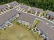 Aerial view of a neighborhood showcasing townhomes with private patios and neat landscaping near green common area at 1141 Amber Shadow Dr # 101, Durham, NC 27703