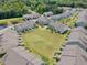 Scenic aerial view of a community with well-maintained lawns and stylish townhomes, surrounded by lush greenery at 1141 Amber Shadow Dr # 101, Durham, NC 27703