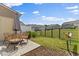 Serene backyard with patio, wicker furniture, and privacy fence ideal for outdoor enjoyment at 1141 Amber Shadow Dr # 101, Durham, NC 27703
