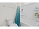 Clean bathroom featuring a tiled tub-shower combo with blue shower curtain and white toilet at 1141 Amber Shadow Dr # 101, Durham, NC 27703