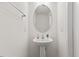 The half bath features a pedestal sink, oval mirror and neutral paint at 1141 Amber Shadow Dr # 101, Durham, NC 27703