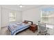 Bright bedroom with natural light, featuring a cozy bed and a dedicated workspace by the window at 1141 Amber Shadow Dr # 101, Durham, NC 27703