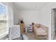 Well-lit Bedroom with crib, dresser, changing table, and comfortable chair at 1141 Amber Shadow Dr # 101, Durham, NC 27703
