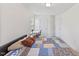 Bedroom with a full-sized bed with a patterned quilt, a small desk, and a large window for natural light at 1141 Amber Shadow Dr # 101, Durham, NC 27703