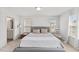Bright, neutrally decorated bedroom featuring a bathroom, a large bed, and a baby swing at 1141 Amber Shadow Dr # 101, Durham, NC 27703