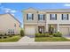 Charming townhome featuring a stone facade, attached garage, and well-manicured landscaping at 1141 Amber Shadow Dr # 101, Durham, NC 27703