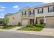Attractive townhome with stone accents, manicured lawn, and an attached one car garage at 1141 Amber Shadow Dr # 101, Durham, NC 27703