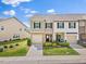 Charming townhome featuring a stone facade, attached garage, and well-manicured landscaping at 1141 Amber Shadow Dr # 101, Durham, NC 27703