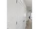 Hallway with white walls, neutral carpet, and white sliding closet doors, providing ample storage space at 1141 Amber Shadow Dr # 101, Durham, NC 27703