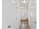 Bright hallway features wood-look flooring, white doors, and a glass paneled front door at 1141 Amber Shadow Dr # 101, Durham, NC 27703