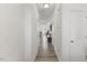 Bright, narrow hallway featuring hardwood floors, white walls, and multiple entryways at 1141 Amber Shadow Dr # 101, Durham, NC 27703