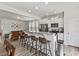 Modern kitchen with stainless steel appliances, white cabinetry, and breakfast bar for casual dining at 1141 Amber Shadow Dr # 101, Durham, NC 27703