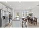 Modern kitchen features stainless steel appliances, granite counters, and island seating at 1141 Amber Shadow Dr # 101, Durham, NC 27703