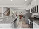 Well-lit kitchen features stainless appliances, granite countertops, and flows into living areas at 1141 Amber Shadow Dr # 101, Durham, NC 27703