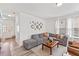 Spacious living room featuring a comfortable grey sectional sofa, and bright natural light at 1141 Amber Shadow Dr # 101, Durham, NC 27703
