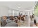 Open concept living space with a grey sectional sofa, and easy access to the kitchen and dining room at 1141 Amber Shadow Dr # 101, Durham, NC 27703