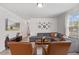 The living room features a sectional, mounted TV, and two leather chairs at 1141 Amber Shadow Dr # 101, Durham, NC 27703