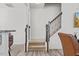 Open staircase featuring wood and iron railing adjacent to kitchen and other living spaces at 1141 Amber Shadow Dr # 101, Durham, NC 27703