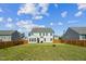 Spacious backyard with grass, partial wooden fence, and cozy patio at 115 Bourne Dr, Franklinton, NC 27525