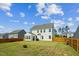 Well-maintained backyard with green grass, wooden fence, and patio at 115 Bourne Dr, Franklinton, NC 27525