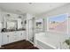 Bright bathroom featuring white subway tile, a glass-enclosed shower, and a soaking tub at 115 Bourne Dr, Franklinton, NC 27525
