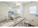 Bathroom featuring a granite countertop with double sinks and a butterfly shower curtain at 115 Bourne Dr, Franklinton, NC 27525