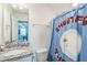 Bathroom featuring granite sink and shower with unique curtain at 115 Bourne Dr, Franklinton, NC 27525