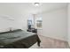 Simple bedroom with carpet, natural light, and minimalist furniture at 115 Bourne Dr, Franklinton, NC 27525