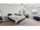Cozy bedroom featuring a tray ceiling, neutral tones, and natural light from the windows at 115 Bourne Dr, Franklinton, NC 27525