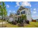 A front corner of the house showing stone accents and a well manicured lawn at 115 Bourne Dr, Franklinton, NC 27525